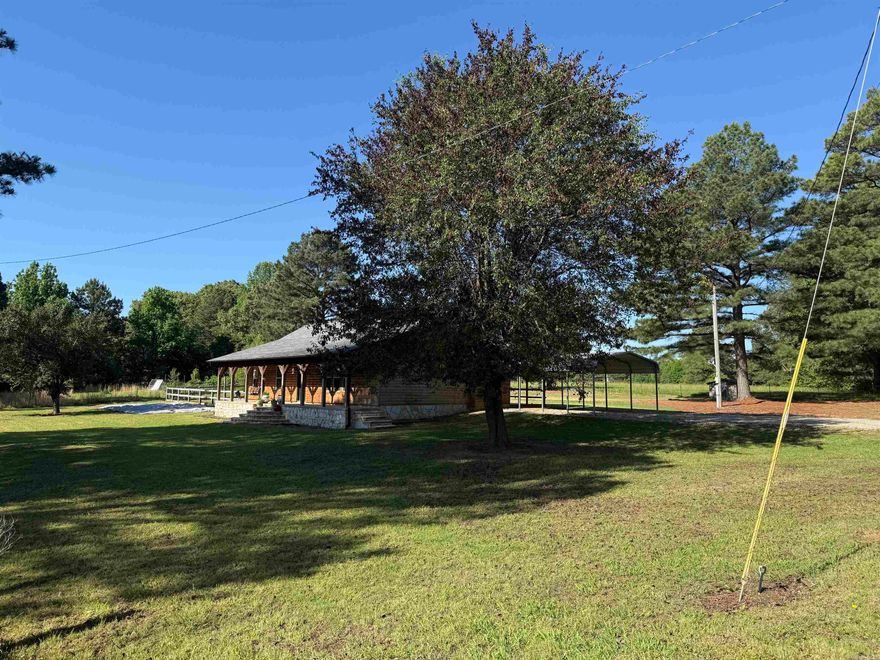 Beautiful 3-bedroom, 2-bath log home on 5 fenced acres near Jonesboro and Brookland, just over a mile from Hwy 351. This rustic country home features pasture space for horses or livestock, a large metal shop, covered deck, and a peaceful setting close to town. Inside you’ll find an oversized living room with vaulted ceilings, knotty pine walls, laminate flooring, ceramic tile in the main areas, and carpeted bedrooms. The primary suite includes a walk-in closet and private bath with jetted tub. A great country property with charm, acreage, shop space, and a convenient location!