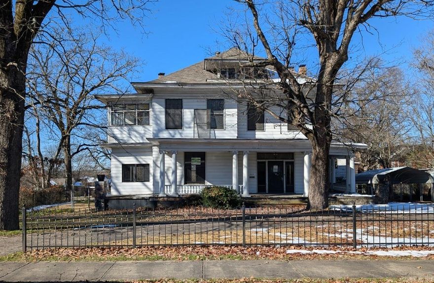 Own a unique piece of history. A chance to restore this stately 2 story to it's original beauty. Built in 1900 with some of the original architecture still intact including wood work, hardwood floors and clawfoot bathtub. Stairs to fully floored attic. Large corner lot with wrought iron fence and circle drive. Detached structure once used as an apartment could also be restored. Property sold "as is" / "where is" / "with All Faults". See agent remarks for showing instructions.