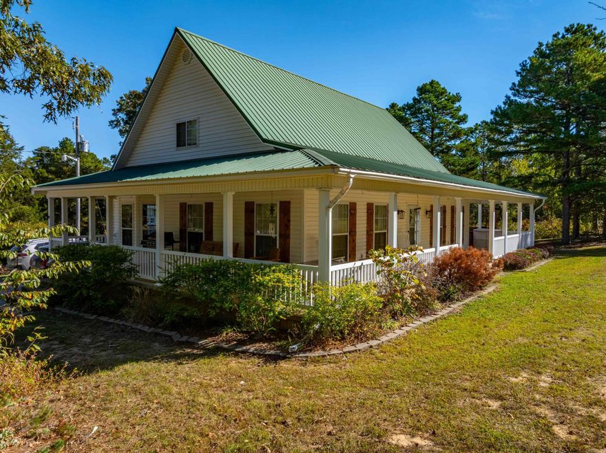 This gorgeous 3 bedroom, 2 bathroom, farmhouse-style home sits on 5 +/- picturesque acres and features a charming wrap-around porch on three sides, perfect for relaxing and taking in the peaceful surroundings. Off one side, you'll find a deck with a swimming pool, offering an ideal space for entertaining or enjoying those hot summer days.As you approach the property, the home's metal roof and scenic pond out back add to its curb appeal. When you step inside, you're welcomed by a grand foyer with stairs leading to the second floor. To the side, the living room opens up to a dining area filled with natural light, thanks to the many windows. Adjacent to the dining room is a spacious, farmhouse-style kitchen with an eat-in bar, perfect for casual meals or gathering with family.The kitchen connects to a convenient laundry room that leads to a spacious garage. Wrapping around the hallway, you'll find the primary suite, which is exceptionally large. It includes a walk-in closet and a luxurious primary bathroom featuring his and hers sinks, a large soaking tub, and a walk-in shower.Upstairs, there are two more bedrooms and a full bathroom, making this home ideal for a family.