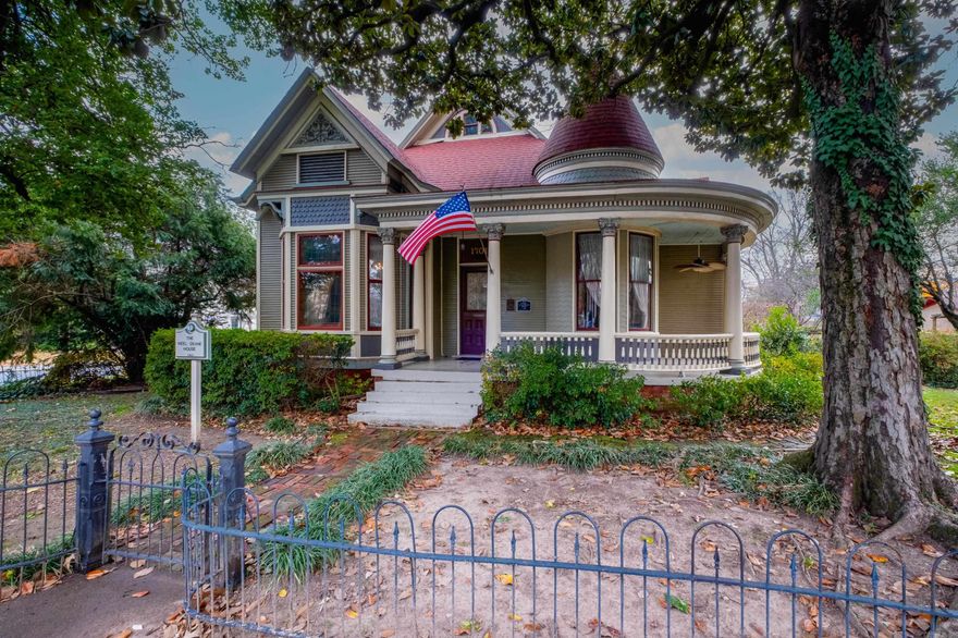 Located in the Governor’s Mansion Historic District, the Neel-Deane House is a rare transitional example blending Queen Anne and Neo-Classical architecture and is listed on the National Historic Register. Built for Gardiner Deane, land commissioner for the Union Pacific Railroad and a key figure in bringing the railroad to the area, this home offers both historical significance and livable spaces. Lovely wood floors, stained glass, wraparound front porch, and a gracious foyer with bay windows and fireplace set the tone. The living room features a fireplace, while the large formal dining room is ideal for gatherings. A spacious en-suite bedroom includes its own fireplace, with two additional large bedrooms sharing a bath. The oversized eat-in kitchen is updated with double ovens and a gas cooktop and opens to a light-filled family room overlooking the back deck and fully fenced yard. Additional features include a wood and iron staircase leading to an upper level bedroom, bath, and storage. The large corner lot is filled with mature trees and beautiful plantings. Parking areas and a detached one car carriage style garage offer a substantial workshop and storage space. Come see.