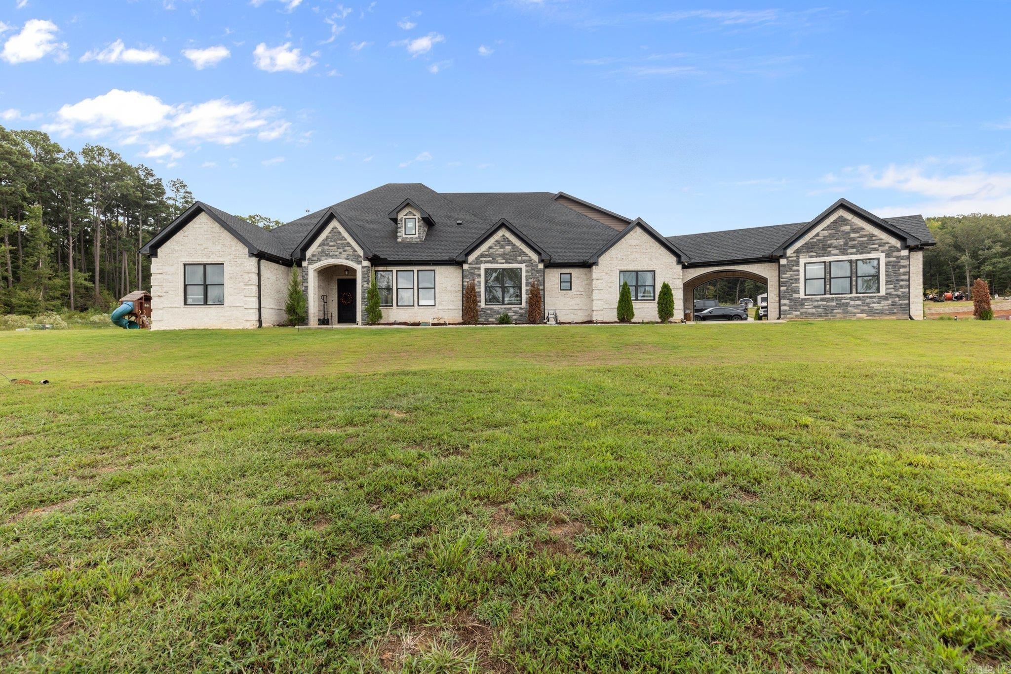 Luxurious Living on 16 Acres! Welcome to your dream home! This exquisite property features a generous 4809 sq. ft. of well-maintained living space, nestled on a 16-acre lot. This stunning residence features 5 spacious bedrooms and 4 bathrooms! The heart of the home is a beautifully designed kitchen, complete with elegant granite countertops and a spacious pantry room. A highlight of this home is the impressive entertainment options, including an entertaining room and a theater, ideal for movie nights or gatherings. Step outside to experience your own private oasis! Enjoy sunny days by the pool, and host gatherings in your pool house, which also includes a bathroom and a convenient storage room. This home also features the perfect space for your own private gym and a 60x80 shop with 3 electric doors. The master suite features a luxurious bathroom, a walk-in closet and a saferoom! One of the guest bedrooms is conveniently located upstairs with its own full bathroom. Completing this remarkable property is a three-car garage, providing ample space for vehicles and storage. Donāt miss this rare opportunity. Schedule your private showing today!