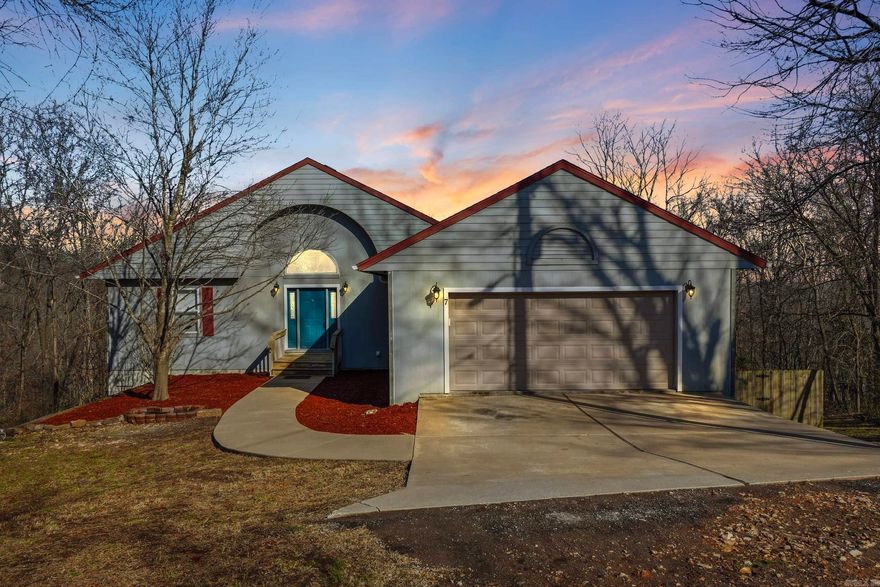 Located at the end of a quiet street, surrounded by acres of woods and direct MTB trail access, this spacious home offers 4 bedrooms and 2.5 baths, plus a family room, office, and an impressive oversized workshop. The living room showcases soaring ceilings and abundant natural light from expansive windows. A large second laundry room on the main level provides excellent flexibility and could easily serve as a craft room or additional indoor storage. Enjoy peaceful views of the woods from the double rear decks. Tucked away on a private cul-de-sac lot, this home offers exceptional privacy and abundant wildlife. The kitchen features generous counter space, a breakfast bar, pantry, pull-out shelving, and a built-in desk area. The lower-level workshop, located beneath the garage, includes double exterior doors perfect for hobbies, projects, or a dedicated workspace. Solar panels will be paid off at closing, saving you an exceptional amount on your utilities monthly. Schedule your showing today!