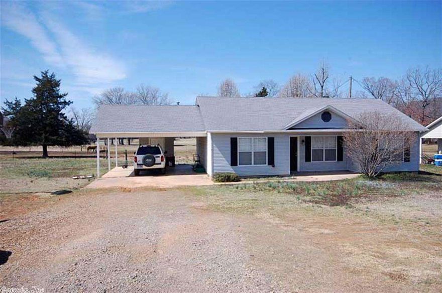This 3 bedroom 2 bath home has a split floor plan and the master bedroom measures 13 feet by 13 feet.  All the bedrooms are carpeted, wet areas are tiled, and living room has hardwood.  The home has an over sized double carport with a storage room.  The home sits on .33 acres with plenty of room to roam.  Come sit on the back deck and enjoy watching the horses while the sun goes down on your very private back yard.  Will