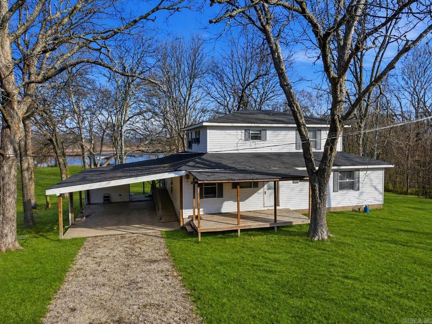 Located on the banks of the Arkansas River in Houston, Arkansas, this riverfront home offers a peaceful setting with scenic views and abundant outdoor enjoyment. Built in 1995, the home sits on a 1.4-acre lot and features four bedrooms and two bathrooms, providing ample space for family or guests.  The interior includes a large open kitchen and living room, creating a welcoming central gathering area. The home is functional but does need updating, offering an excellent opportunity for customization and improvement. Heating is provided by space heaters, with window units used for cooling.  Spacious porches and decks extend the living space outdoors, ideal for relaxing and taking in the tranquil surroundings. A riverside pavilion adds a perfect spot for entertaining or enjoying quiet moments by the water. Fishing from the riverbank is easily accessible, enhancing the property’s appeal for outdoor enthusiasts.  With its peaceful atmosphere, scenic river views, and generous lot size, this property offers a unique chance to enjoy laid-back riverfront living with room to make it your own.