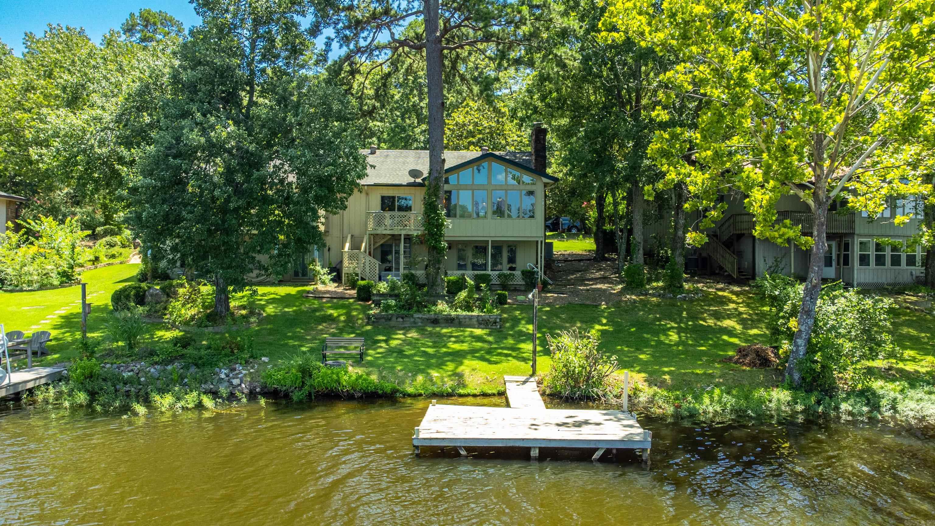 Enjoy lakefront living in this cozy 2BR/2BA townhouse located in the heart of Hot Springs Village the largest gated community in the U.S.! Perfect for downsizers or those seeking a peaceful retreat, this home offers a flexible and spacious layout with a living room, a separate den for relaxing or working from home, and a bright sunroom with serene views of the lake. Recent updates include a brand-new HVAC system installed in 2024 for year-round comfort. Step outside to enjoy lakeside strolls, or take advantage of the incredible amenities Hot Springs Village has to offer from golf courses and nature trails to lakes and community events. This low-maintenance lakefront gem blends convenience, comfort, and charm in a secure, vibrant community. Don't miss your chance to live the lake life!