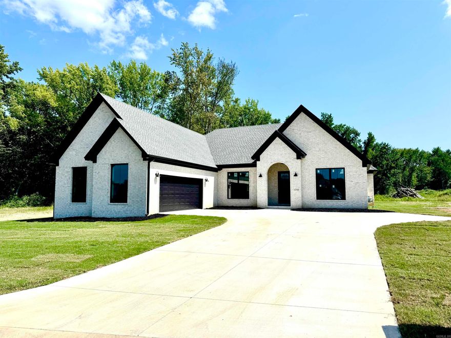 This stunning custom-built 4-bedroom, 3-bath home offers an open floor plan designed for comfort and functionality. The eat-in kitchen features a breakfast bar, walk-in pantry and ample space for family gatherings. A separate formal dining room adds elegance for special occasions. The great room with a cozy gas log fireplace creates a focal point. The primary suite boasts his and her walk-in closets, a large custom tile shower, and a dressing table for convenience. Enjoy outdoor living on the covered patio Located in one of Searcy's most desirable neighborhoods, this unique home is truly a must-see!