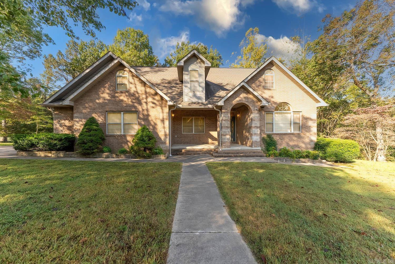 This spacious brick home offers four bedrooms and three bathrooms, providing ample space for comfortable living. Nestled near Buzzard Roost boat dock, you'll enjoy the tranquility of nature while being close to city amenities.  The home's brick exterior and vaulted ceilings create a welcoming atmosphere. Imagine waking up to the sounds of nature and enjoying easy access to the lake for boating, fishing, or simply relaxing by the water. You may even spot some of the area's wildlife as you enjoy the peaceful lakeside retreat.  Don't miss this opportunity to make this peaceful lakeside haven your own. Schedule a private showing today and discover the lifestyle you've been dreaming of.