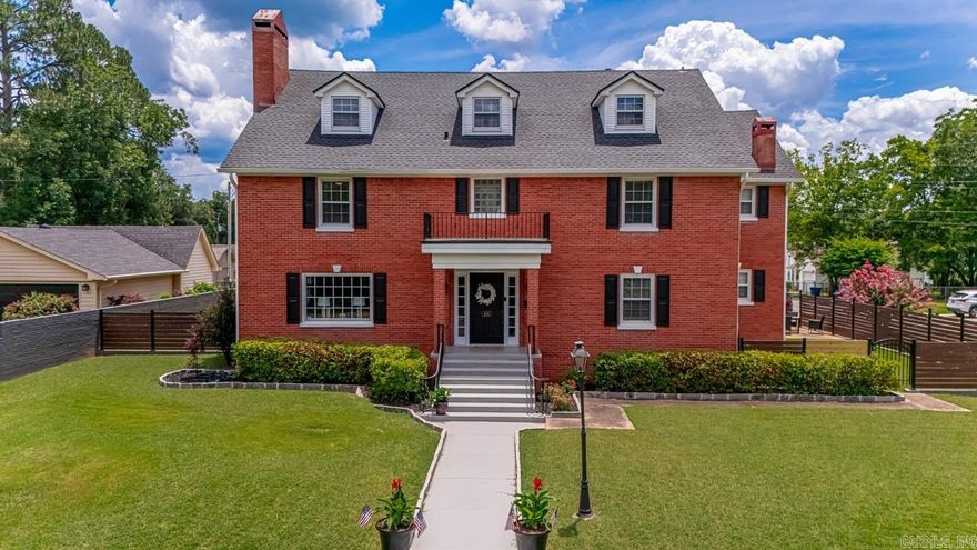 This stunning classic home has been thoughtfully updated, keeping its mid century charm while providing the conveniences of modern living. Your grand entrance takes you to a formal sitting room and private office. You will love the formal dining room and updated kitchen with plenty of storage. Upstairs find oversized 4 bedrooms and 3 full plus 1 half bath. The third level is a dream space for hanging out, playing pool, reading and crafts. This is on a corner lot with a large 4 car garage, flat back yard, and huge sitting porch. The downtown Benton location makes for walkable living and easy access to all the restaurants, schools, and shopping.