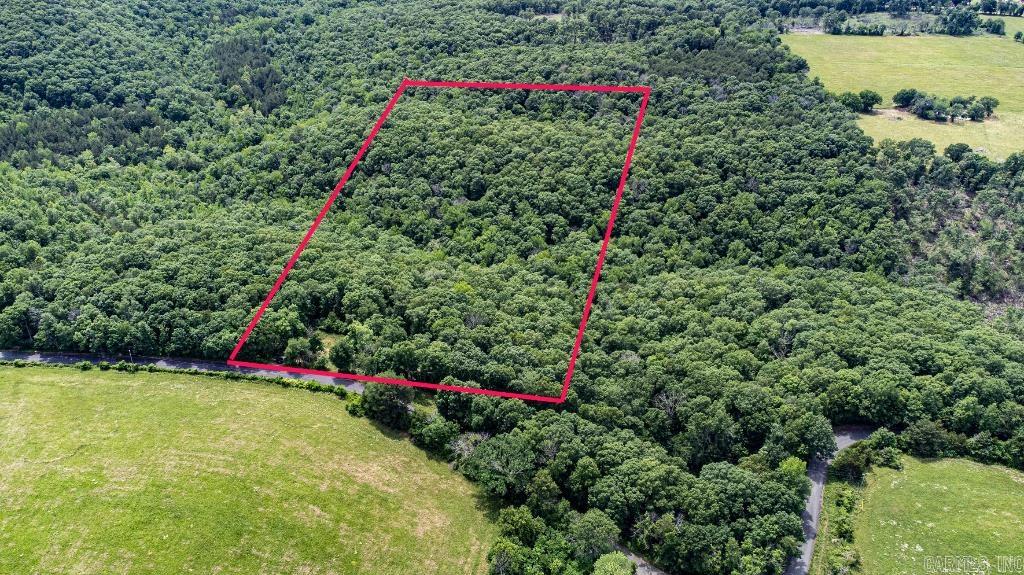 Partially cleared 10-acre lot with year-round creek, house pad, septic, and driveway already installed. Power available at the road (Petit Jean Electric); well needed. No zoning or restrictionsāmobile homes welcome. Not in a floodplain. Easy access off a paved road. Some hilly terrain. Neighboring tracts lack these improvements. Owner financing available. Low annual taxes. Ideal for building, homesteading, or investment.