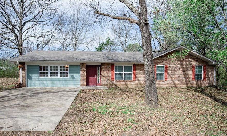 BRICK RANCH STYLE HOME with roomy 4 Bedrooms and 3 Bathrooms, including a luxurious jetted tub.  There is a large tree-shaded yard providing a parklike setting.  The spacious wood deck off the kitchen and dining area gives an invitation for you and your guests to linger outside in nature.  The fully equipped kitchen has been remodeled with hickory cabinets.  New AC compressor unit in the summer of 2023.  New windows installed in 2019.  It has had a home efficiency audit to reduce utility bills.  New roof shingles in 2024.  Easy access to the Ouachita Mountain area, including downtown dining, the Ouachita National Forest, Wolf Pen Gap Trail System, hunting and fishing, and the bike trails said to be coming soon.  If interested in an AIRB&B, this property is fully furnished and you could start immediately.  Call us when you can take a look.