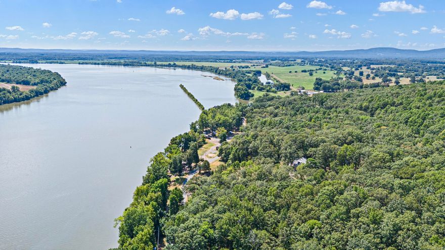 SCENIC STAYS**SOLID RETURNS**PETIT JEAN POWER!  – 22.89 Acres on the Arkansas River & Petit Jean Mountain. This is a rare chance to own a multi-stream income-producing property in one of Arkansas’ most iconic tourist destinations! All fully operational and well maintained. *The property features three homes—including a spacious main residence with a sparkling private pool and extra bunkhouse, all currently used as successful short-term rentals with a history of strong bookings and repeat guests. Everything is fully furnished and stocked, along with all the maintenance equipment needed to operate with ease. A new main office has been added. The retreat also includes a riverfront RV park, attracting loyal travelers and monthly guests year after year who enjoy fishing, boating, Hiking and the stunning sunrise on the water. *Additionally, it comes with wedding venue furniture and supplies plus breathtaking river-view ceremony spots, opening the door to another large and profitable income stream.  For many pictures of one of the homes and wedding venue visit: www.vrbo.com/7895277ha
