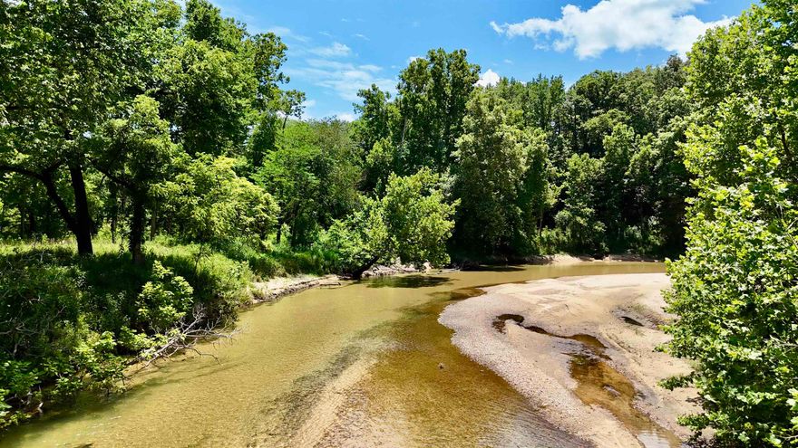 8.65 ACRES WITH CREEK FRONTAGE! Have you been dreaming of owning a piece of property on a year round creek where you can build your dream home or cabin? This property offers 337.5 ft of creek frontage on Mill Creek with crystal clear water and sandy beaches! This property has great access down to the water, fantastic hill to build on, wooded area for privacy and a large open field! Access to electric & Fiber Internet!  Easy to navigate in a kayak all the way to the White River. This property is secluded but not far from town!