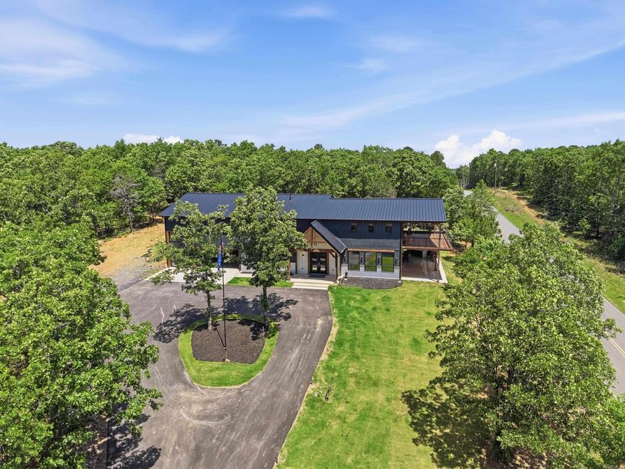 Welcome to 491 Stone Mountain Rd in Conway, Arkansas — a one-of-a-kind modern barndominium offering approximately 3,500 SF of heated and cooled living space plus a 1,200 SF shop area in a prime Central Arkansas location with easy access to Conway, Little Rock, Cabot, and Searcy. This custom home features 3 full baths, 2 half baths, and nearly 1,900 SF of outdoor deck space designed to maximize the incredible views, including views of the Jacksonville Air Force Base landing strip. The luxurious primary suite offers a spa-like wet room with a soaking tub inside the oversized shower plus a programmable steam system for essential oils, creating a true in-home sauna experience. The shop area includes RV hookups and ample space for hobbies, storage, or recreational vehicles. Additional highlights include hot and cold exterior water faucets perfect for washing vehicles or pets and pre-wiring for a whole-home generator. This property seamlessly blends luxury, functionality, and modern design in a truly unique setting.