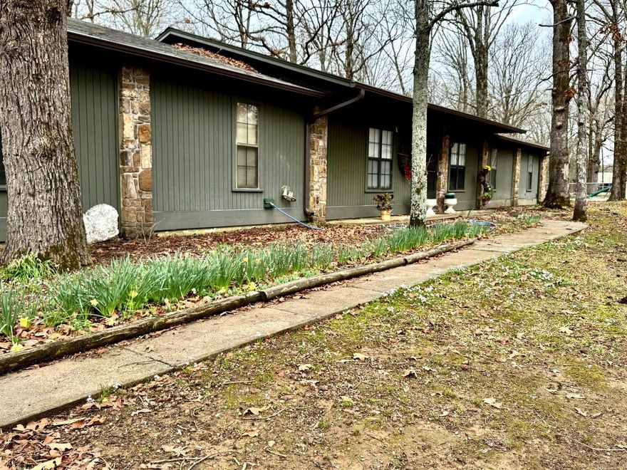 Set on approximately 2.75 acres in Conway, this property offers space, comfort, and convenient access to major shopping, dining, and everyday amenities. The home features 4 bedrooms and 2.5 baths with multiple living areas including a spacious family room and separate den, providing flexibility for relaxing or entertaining. A welcoming living space centers around a stone fireplace, while large windows bring in natural light and views of the surrounding property. The kitchen offers generous cabinet space, stainless appliances, and a large island that connects easily to the dining area. A large mudroom/laundry area adds practical everyday functionality. Outside, mature trees create a peaceful setting across the 2.75-acre lot, with room to enjoy outdoor living. The property also includes a detached garage/workshop and storage building, offering additional space for projects, equipment, or hobbies—all while remaining just minutes from Conway conveniences.