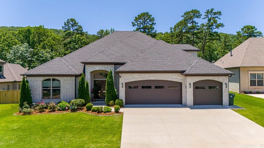 This stunning home boasts a blend of modern architecture with a highly desired floor plan that lives like a one-story home featuring four bedrooms and three full bathrooms on the main level. Guests are welcomed by the foyer and 12-foot ceilings leading to an open-concept floor plan where the great room, kitchen and dining space is seamlessly intertwined. The gourmet kitchen features beautiful granite countertops, GE Profile appliances, a spacious island with bar stool seating and a walk-in pantry. Tucked away for privacy, the primary bedroom suite offers a spa-like bathroom boasting a his and her vanity with quartz countertops, soak tub, and spacious shower. Two additional guest bedrooms share a jack-and-jill bathroom. The fourth guest bedroom offers hardwood floors and walk-in closet (used as an office) positioned next to a hall bathroom. The enclosed sunroom overlooks the backyard featuring a fireplace with gas logs. Additional features include a media room upstairs, three car garage and incredible backyard with raised beds for gardening which backs up to green space. This home is walkable to the neighborhood pool!  Come see!