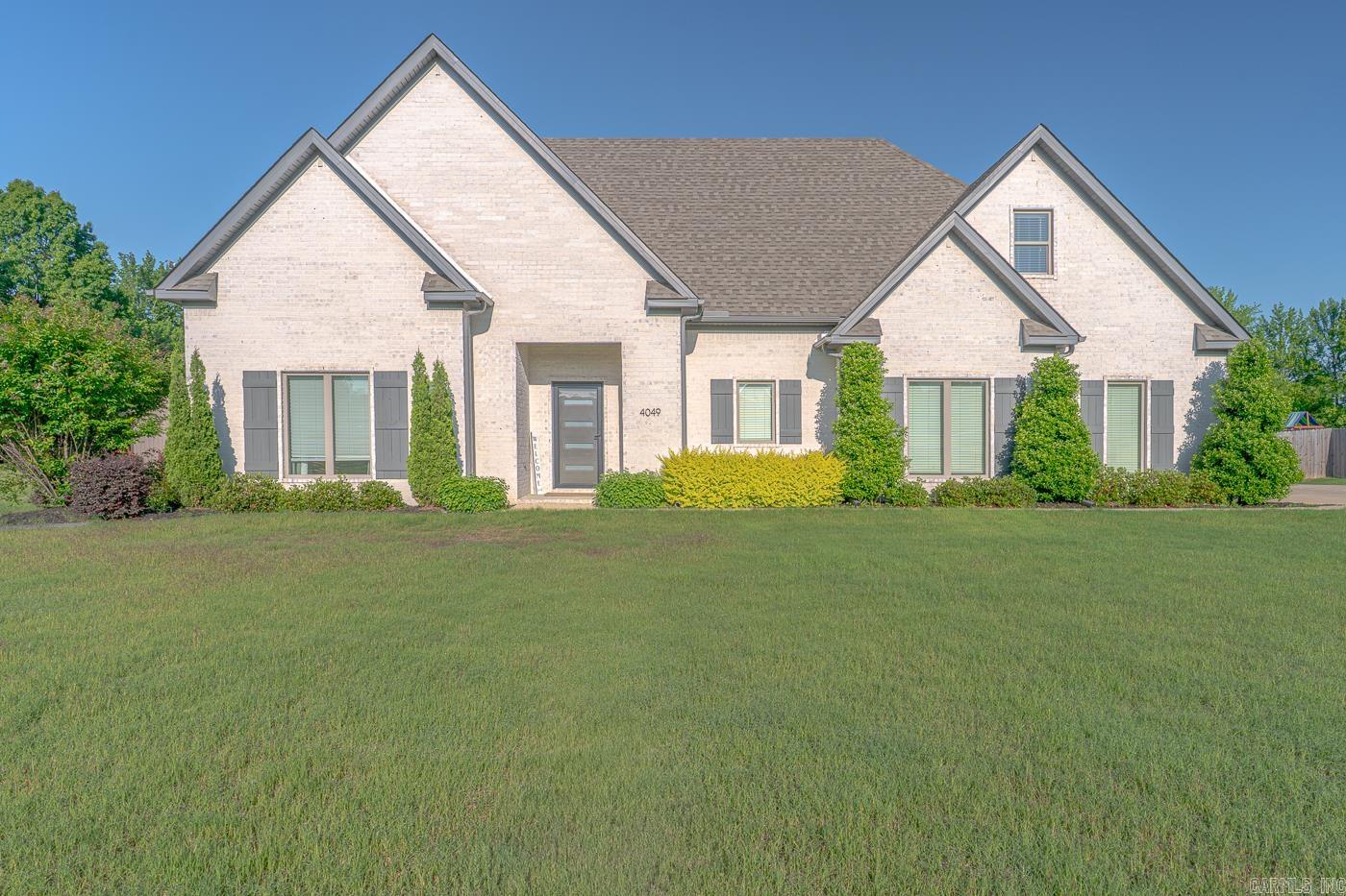 Welcome to Market 4049 Hwy 351 in Jonesboro, AR within the Brookland School District. Situated on 1.92 level acres is a 2020 built beauty wrapped in brick, topped w/ architectural shingles, and accented by a 2 car side entry garage, shutters, gutters, and beautiful landscaping. The interior features 2,921 sf of well laid out living space. On the main is an open concept living/kitchen/dining area. The living room features a cozy gas fireplace w/ tile surround and the eat-in kitchen holds a quartz topped island w/ bar seating, stainless steel appliances, gas range, walk-in pantry w/ coffee bar, and access to the covered patio w/ solar shades. The Master wing holds a generous bedroom and en-suite w/ dual vanity, slipper tub, tiled walk-in shower w/ built-ins, and walk-in closet connected to the laundry/mudroom. The spare wing features 2 bedrooms and full bathroom w/ shower/tub combo. Upstairs is the 4th bedroom, bonus room, and a full bathroom w/ shower/tub combo. You'll love the mud room, hardwood floors, custom cabinetry, ample storage, EV charger, Nest thermostat, outdoor shades, and the fencing and water fountain in the backyard. Call today to make this house your home.