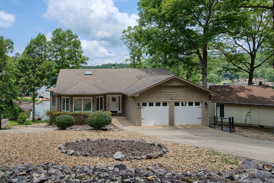 Just bring your clothes! This cool Lake Cortez home offers everything you're looking  Open view of the lake from most rooms, 3 bedrms, 2 1/2 baths, wood, tile and carpet flooring.  Vaulted ceiling with beams, fireplace, kitchen open to dining and  living area.  Kitchen has quartz counters and newer appliances. Screen Porch off primary bdrm. Walk-in showers in both baths. Skylights and plantation shutters- Lower level has laundry room and 2 bedrooms, full bath.  Nice size deck, maintenance free landscaping with fire pit. Furniture and appliances are included.  Approx. 2586 heated and cooled square feet. 2 Car Garage-