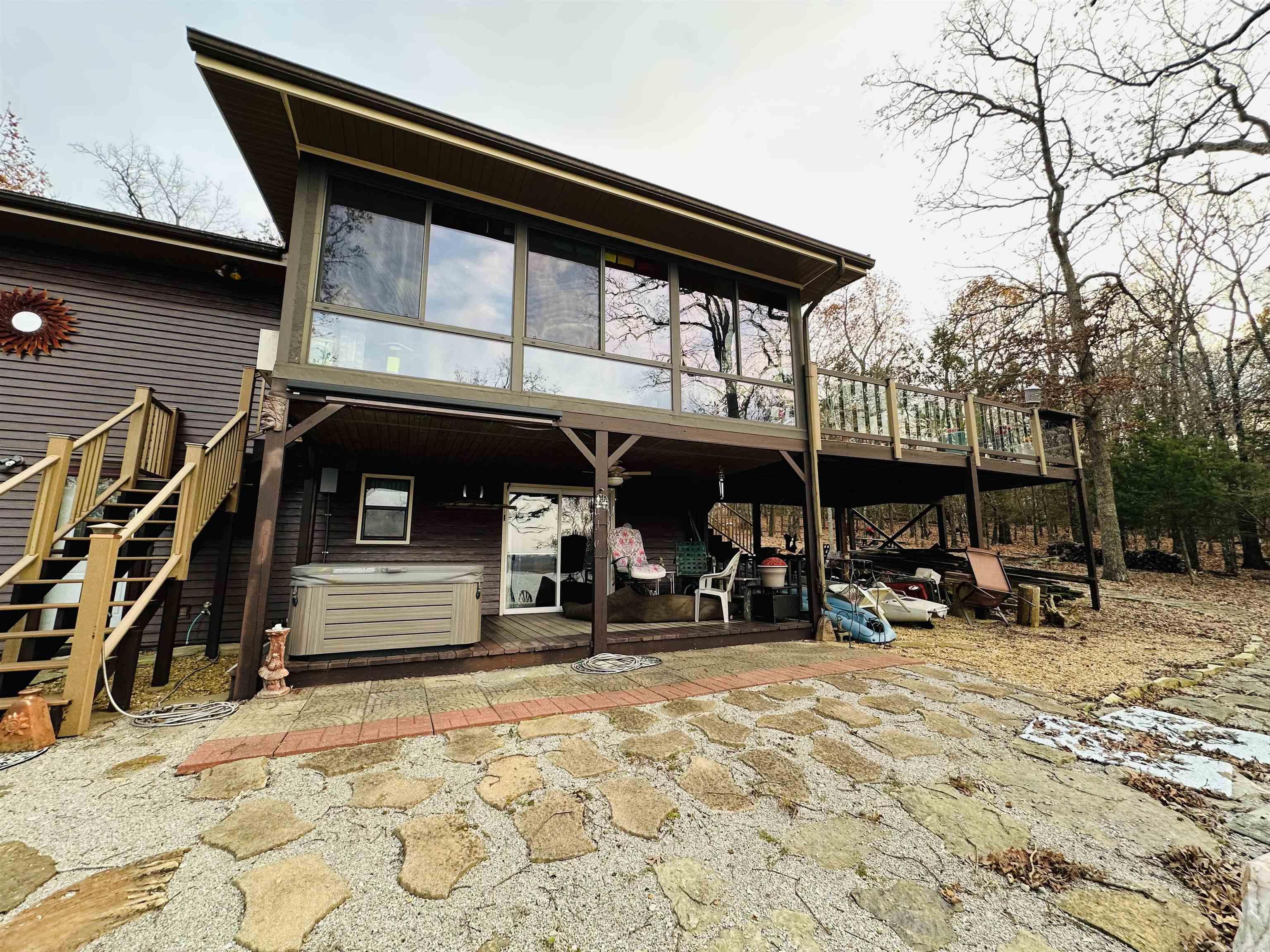 Panoramic views with an easy walk down to Bull Shoals Lake. This 3100 sq ft, 3 bedroom, 2 bathroom, has end of the road privacy on a wooded peninsula surrounded by wildlife and walking trails. Native stone and quartz inlaid fireplace, tongue and groove accents throughout. Enjoy lake sunsets while you sit in your sun room, on the large main level deck, or from lower patio in the hot tub. Home is built on 0.9 AC M/L, leased from the US Army Corps of Engineers, on a 25 yr renewable lease with $510 yearly fee. All appliances convey "as is".