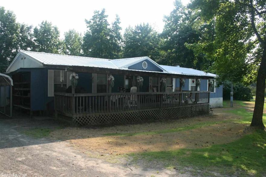 Extremely nice double wide at the end of the road. Many walls are textured and painted fresh colors. Gas Range in Kitchen with lots of cabinets and beautiful built ins with glass doors, built in gun rack. Large Front Room and Den with Fireplace. New vinyl in Master Bath, Walk-in closets, Metal Roof, 2 rooms added to back for additional uses. Large Covered deck.  Just around the corner from Sugar Loaf Rec Area and Marina. Minerals are not owned by seller.