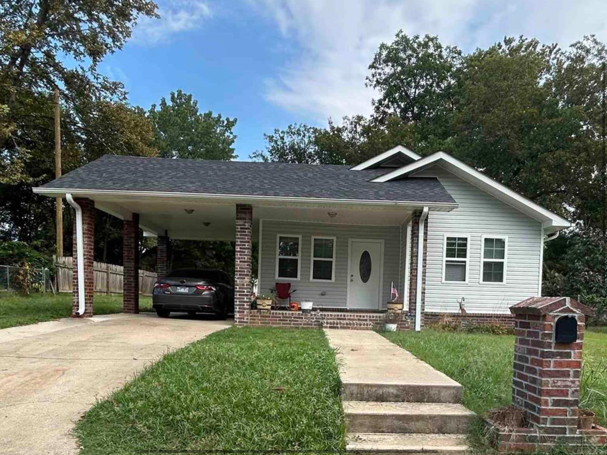 Completely remodeled just one year ago, this charming 3-bedroom, 2-bath home offers modern comfort and style in a convenient location just west of downtown Morrilton. With 1,260 square feet of thoughtfully designed living space, this property combines updated features with cozy charm. Step inside to an open-concept living and dining area, perfect for gatherings and everyday living. The kitchen is equipped with nearly new appliances, while the spacious master suite boasts a large walk-in closet and private bath. Recent updates include a new roof, HVAC system, water heater, and appliances—all approximately one year old, giving you peace of mind for years to come. Outside, enjoy the sizeable lot with a fenced yard on three sides, a carport for covered parking, and a cute covered front porch with plenty of space to decorate or relax outdoors. Move-in ready and beautifully updated, this home is a must-see!