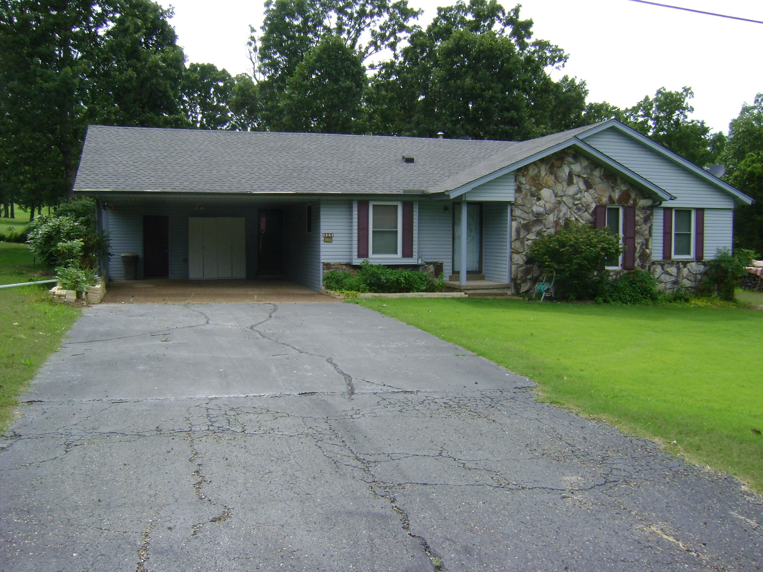 GOLF COURSE house with a great view of the course and club house with two lots is now on the market. It has three bedrooms, one bath, laundry room, sunroom, two car carport, refrigerator, stove, microwave, dishwasher and ceiling fans. Hardwood, tile and carport floors. Central heat and air heat pump with a wood burning fireplace with insert and seasoned fire wood stacked on the property. This house has a water softener, city water, sewer and high speed fiber internet. Newer windows and roof and the chimney was cleaned this year. Large covered deck, with extra landscaping for your outdoor enjoyment. Come see hit house before you miss out today.