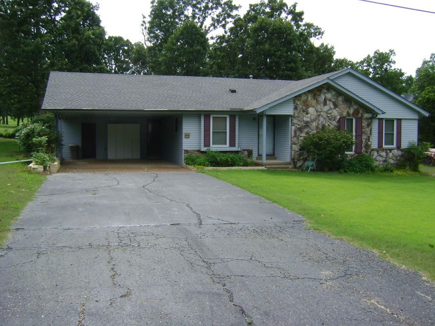 GOLF COURSE house with a great view of the course and club house with two lots is now on the market.  It has three bedrooms, one bath, laundry room, sunroom, two car carport, refrigerator, stove, microwave, dishwasher and ceiling fans.  Hardwood, tile and carport floors.  Central heat and air heat pump with a wood burning fireplace with insert and seasoned fire wood stacked on the property.  This house has a water softener, city water, sewer and high speed fiber internet. Newer windows and roof and the chimney was cleaned this year. Large covered deck, with extra landscaping for your outdoor enjoyment.  Come see hit house before you miss out today.
