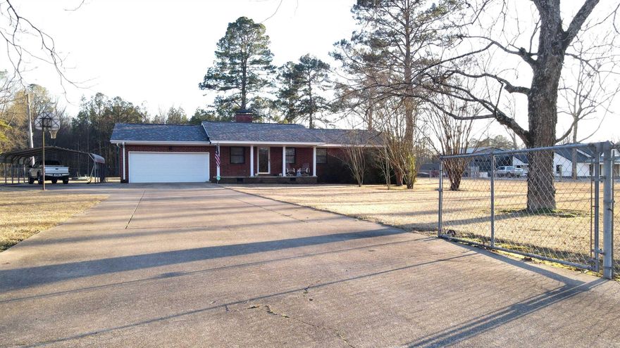 This is a beautiful country setting but still close to all the amenities of town.  The yard and pasture area are well kept and manicured. There are 3 bedrooms, 1.5 bath (Add'll space available to add shower), covered deck with hot tub connections and swing, 2 car garage plus extra 2-car carport, nice storm shelter and 2 outbuildings, 1 is used as a shop, a garden spot and the chicken coops ready to use.  All of this makes it the perfect place to call home. Comes partially furnished. Call today for a showing!