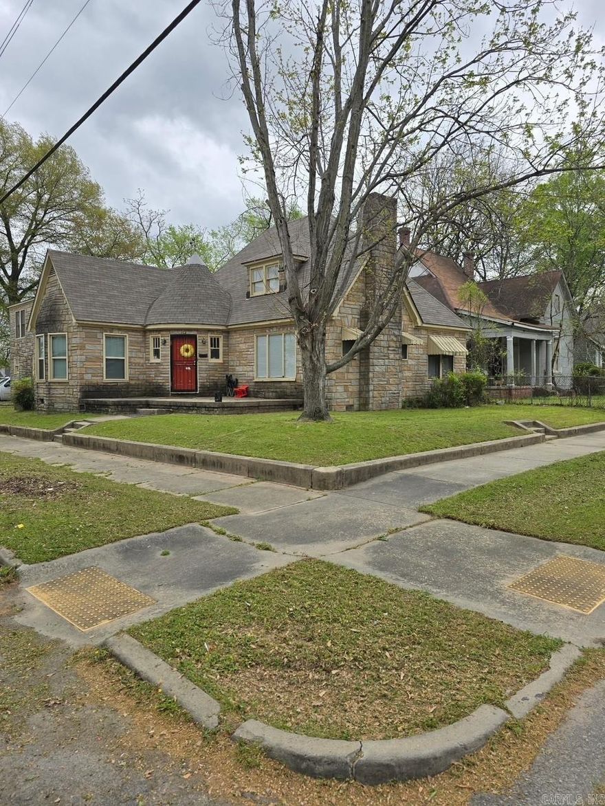 Great Investment Opportunity. This charming 1940's style rock home blends timeless character with solid income potential.  Situated on a prominent corner lot, this unique property features classic stone exterior, steep gabled rooflines, and vintage architectural details that stand out. Configured as a 4-plex, the property includes one spacious 3-bedroom unit and three 1-bedroom units.  The large corner positioning provides added curb appeal with multiple access points.  While one unit is currently unoccupied--this offers buyer the opportunity to live in one unit!  3 of four units are currently occupied.  Unit 1 $1080: Unit 2 500: Unit 3 $500: Unit 4 Vacant.   The expenses include some utilities from when properties were vacant as well as repairs.  No SPD to be provided.