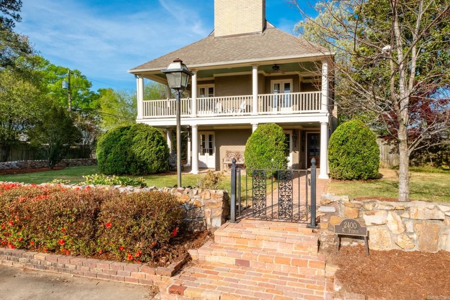 Commanding a quarter-acre corner lot, this Heights home masterfully blends historic charm and modern luxury. A brick pathway leads to a gracious two-story covered porch framed by classic columns, beadboard ceilings, and gas lanterns. Inside, the layout easily accomodates busy lifestyles and gatherings of family and friends. The formal living room boasts a sleek marble fireplace, while the spacious back den warms up with rich hardwoods and a classic brick hearth. The chef's kitchen is the true heart of the home, equipped with a professional Wolf gas range, custom white cabinetry, granite countertops, and a seamless flow into formal and casual dining spaces. Upstairs you'll find four bedrooms highlighted by a primary suite retreat complete with its own romantic fireplace and private balcony. Incredible bonus spaces elevate the property even further, including a bright hobby room with built-in workspaces and an adjacent laundry room with an adjoining full bathroom. The third-floor features a game room and a climate-controlled storage room. From the plantation shutters to the gleaming hardwoods, every inch of this home is designed for stylish, comfortable Heights living.