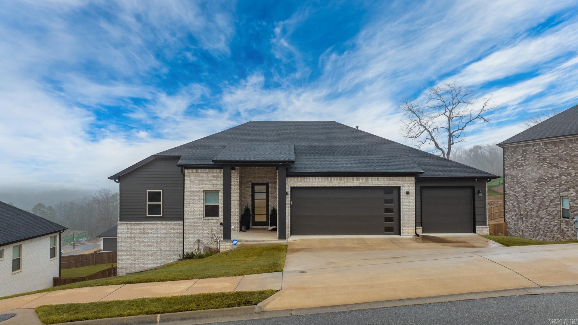 Stunning like new home built in 2024 with breathtaking sunset views! The open concept design features a spacious living area with an upgraded gas Heatilator fireplace and expansive windows across the back, filling the home with natural light. The gorgeous eat in kitchen and dining area is perfect for entertaining and includes custom cabinets, upgraded GE Cafe appliances, a large center island, and a walk-in pantry. The main level primary suite offers a luxurious double walk in shower, soaker tub and a huge closet also accessing the laundry room. A dedicated office/study area adds versatility. The lower level features three bedrooms, two baths, a bonus/game/flex room, and an unfinished expansion space off the bonus as well separate storage room with outdoor access. Enjoy spectacular views from the main level deck and lower level covered patio overlooking the large yard. Three car garage, tankless HWH and top of the line security system. Come see!