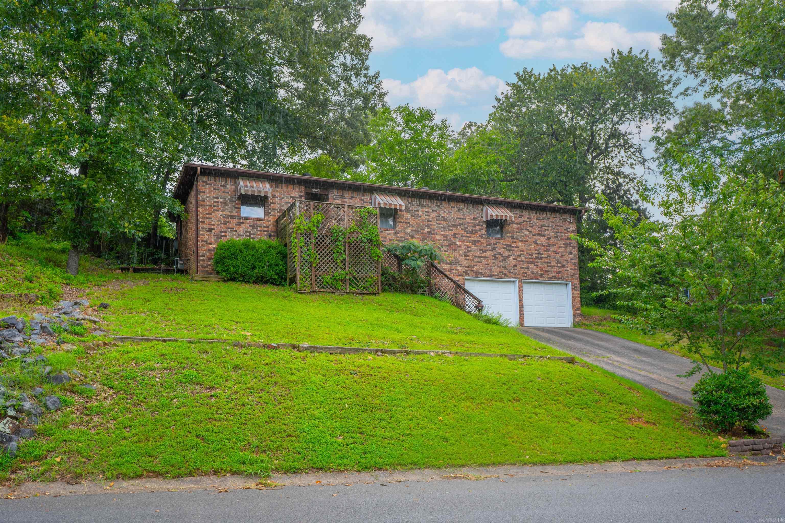 Great space buy in desirable Lakewood right across from Lake #3. Two car garage downstairs, and 3 beds/2 baths upstairs with updates throughout like newer cabinets, granite countertops, LVP flooring throughout living area, and updated fixtures. Great floor plan with open kitchen/dining/living room with large brick fireplace. Perfectly situated across from the park and optional Lakewood POA amenities including pavilion, basketball courts, playground & bike/walking trails. Conveniently located close to The Old Mill, shops, grocery & restaurants.