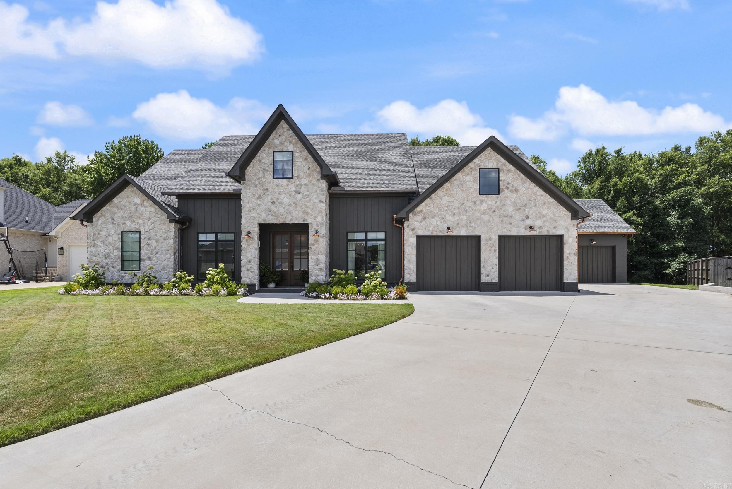Step into refined elegance in one of Conway’s most desirable neighborhoods. This exquisite custom-built home offers over-the-top upgrades, an energy-efficient design, and a layout perfect for everyday living or entertaining in style. The open-concept kitchen stuns with floor-to-ceiling Custom Cabinetry, Quartzite countertops, a walk-in pantry, butler's pantry, Gas Stovetop w/ Pot Filler, Double Ovens, and a Spacious island that anchors the heart of the home flowing to the living room featuring the fireplace, designer finishes, and expansive windows that invite in natural light. Retreat to the primary suite on the main level of the home with a spa-worthy en-suite bath featuring double vanities, a soaking tub, and an oversized walk-in shower. Don’t miss the dreamy closet with built-in storage and center island. The Secondary bedrooms are generously sized with ample closet space and beautifully appointed bathrooms. Additional highlights include indoor Safe room, dedicated home office, formal dining room, and a private, wooded backyard oasis. The expansive covered patio sets the stage for quiet morning coffee or relaxing evening gatherings. Let's make this one your next home!