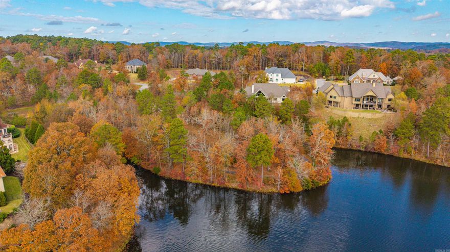 Scenic Lakefront Peninsula Lot in Gated Red Oak Ridge! Discover one of the most desirable home sites in the beautiful private community of Red Oak Ridge. This mostly level, custom home lot sits on a peaceful peninsula surrounded by natural beauty and stunning lake views. Enjoy miles of scenic walking paths that wrap around the lot, two fully stocked fishing lakes, and a sparkling community pool. Red Oak Ridge offers the perfect blend of nature and luxury living, with added conveniences like a community boat parking area right next to the boat launch. Build your dream home and experience lakefront living at its finest—peaceful, private, and perfectly positioned for enjoying the best of Hot Springs!