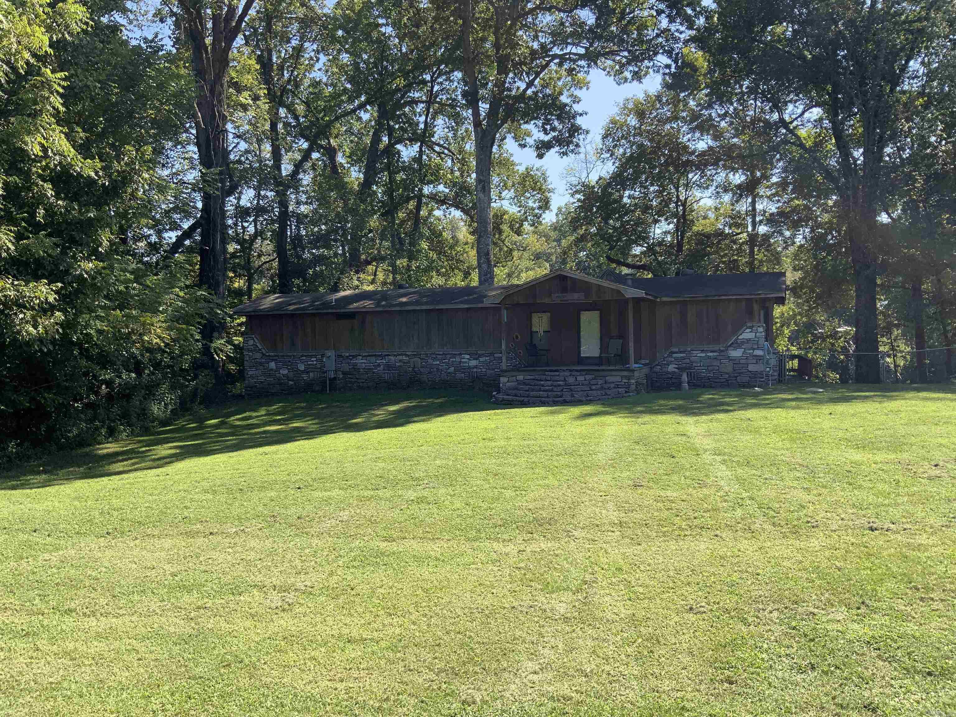 MUST SEE ON THE LITTLE RED! This property has lots to offer with 2 living areas 3 bed 3 bath on 1/2 acre. A beautiful cathedral ceiling cedar room with large windows to view the river and enjoy family and friends. The lower living area offers a kitchenette and a beautiful custom tiled walk-in shower. Outside you will find the wrap around deck and a step down deck that contains a hot tub for relaxing after a long day of fishing! You will also enjoy your personal dock with a lift. This property is priced to sell! Call today for a personal tour!