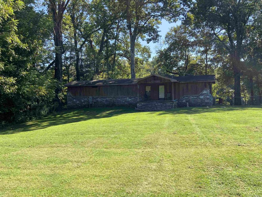 MUST SEE ON THE LITTLE RED! This property has lots to offer with 2 living areas 3 bed 3 bath on 1/2 acre. A beautiful cathedral ceiling cedar room with large windows to view the river and enjoy family and friends. The lower living area offers a kitchenette and a beautiful custom tiled walk-in shower. Outside you will find the wrap around deck and a step down deck that contains a hot tub for relaxing after a long day of fishing! You will also enjoy your personal dock with a lift. This property is priced to sell! Call today for a personal tour!