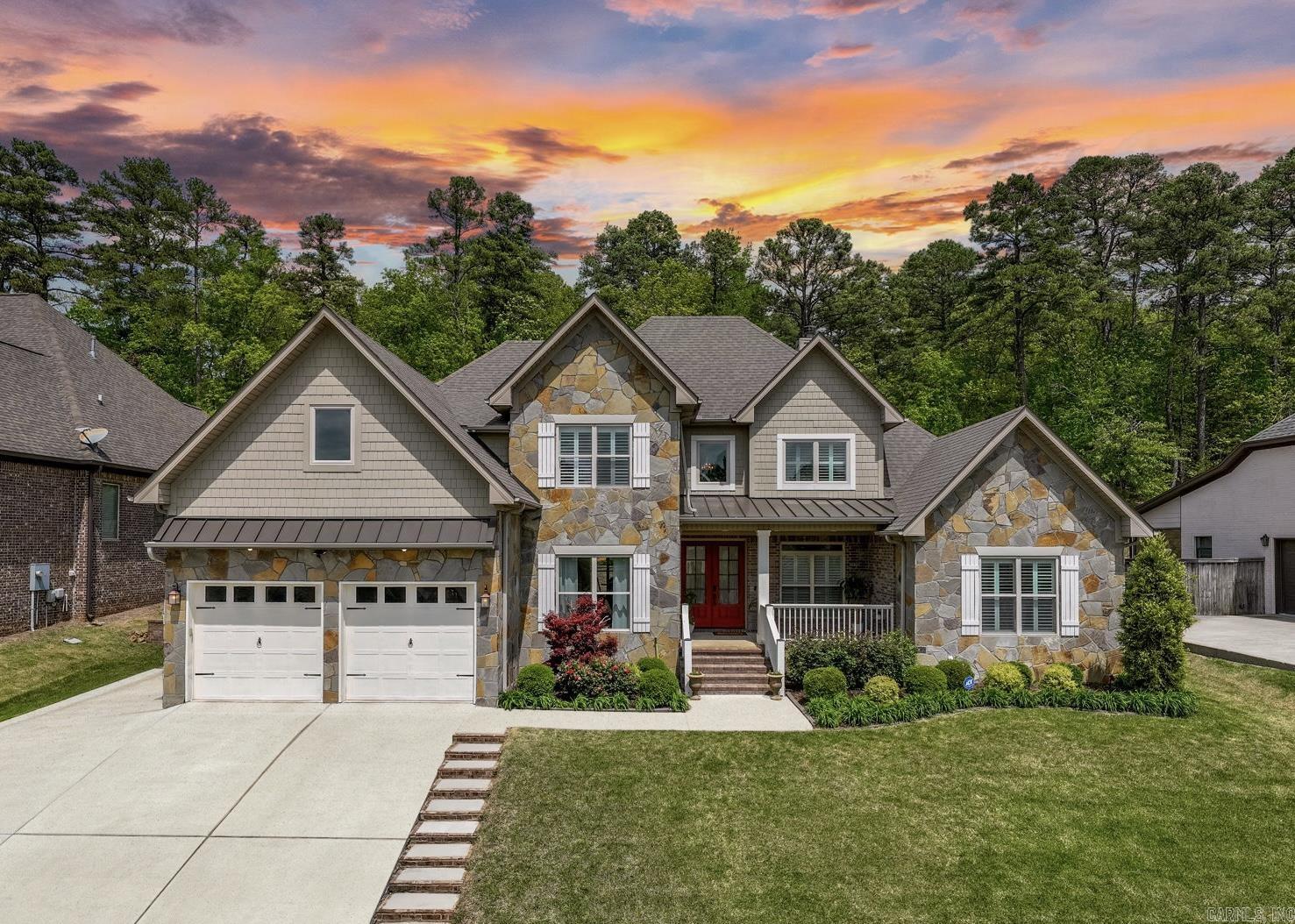 Tucked into one of Little Rockās favorite neighborhoods, this stone-clad beauty sits on a private lot that backs to protected green spaceāwhere birdsong and wooded views greet you daily. Inside, soaring ceilings, warm hardwood floors, and a natural flow from the dining room to the living area with fireplace create a space thatās both refined and welcoming. The kitchen anchors it all with rich cabinetry, granite counters, and an open layout perfect for slow mornings, meal prep with friends, or lively holiday gatherings. The main-level primary suite offers a quiet retreat with patio access, dual closets, and a spa-like bath featuring double vanities and a jetted tub. A guest suite, flexible office or nursery, and laundry room complete the first floor. Upstairs, youāll find three generously sized bedroomsāincluding one currently used as a media roomāand a full bath with double vanities. But the real magic happens out back: a covered patio extends to tiered garden beds, where the treetops sway and time slows down. From coffee at sunrise to dinners under the stars, this private greenbelt retreat is where everyday moments turn memorableāand where life feels just a little more peaceful.