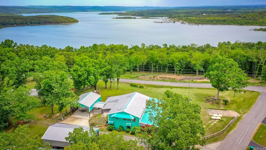 Stunning Panoramic views of Greers Ferry Lake overlooking Higden Bay! A total of 8 lots including approximately 4 acres!!(4 lots with the home & 4 lots across the street to maintain your amazing lake & vista views! This property is so unique & one of kind, you won’t find another one like it.The sellers have lived here full time since home was built & includes whole house backup Generac Generator (done by Mr. Sparky & on its own propane tank that will stay), Clean Storm Shelter, a huge sleeping porch with a 1/2 bath & setup w/kitchenette space including sink, refrigerator, TV, washer/dryer, bed,  & Bistro Table (such a cool space, you must see.Wood burning stove can be negotiable for separate price).The Cabin will come mostly furnished (sellers have some personal items that won’t stay throughout like the bedroom furniture in the downstairs bedroom that was seller’s moms & some other select items). All kitchen appliances in the home will stay including the gas space heaters. Home has central heating & air,24x30 attached carport , 30x50 detached garage, RV hookups, Primary Bedroom has walk out screened porch off sliding glass door, & oversized walk in shower.