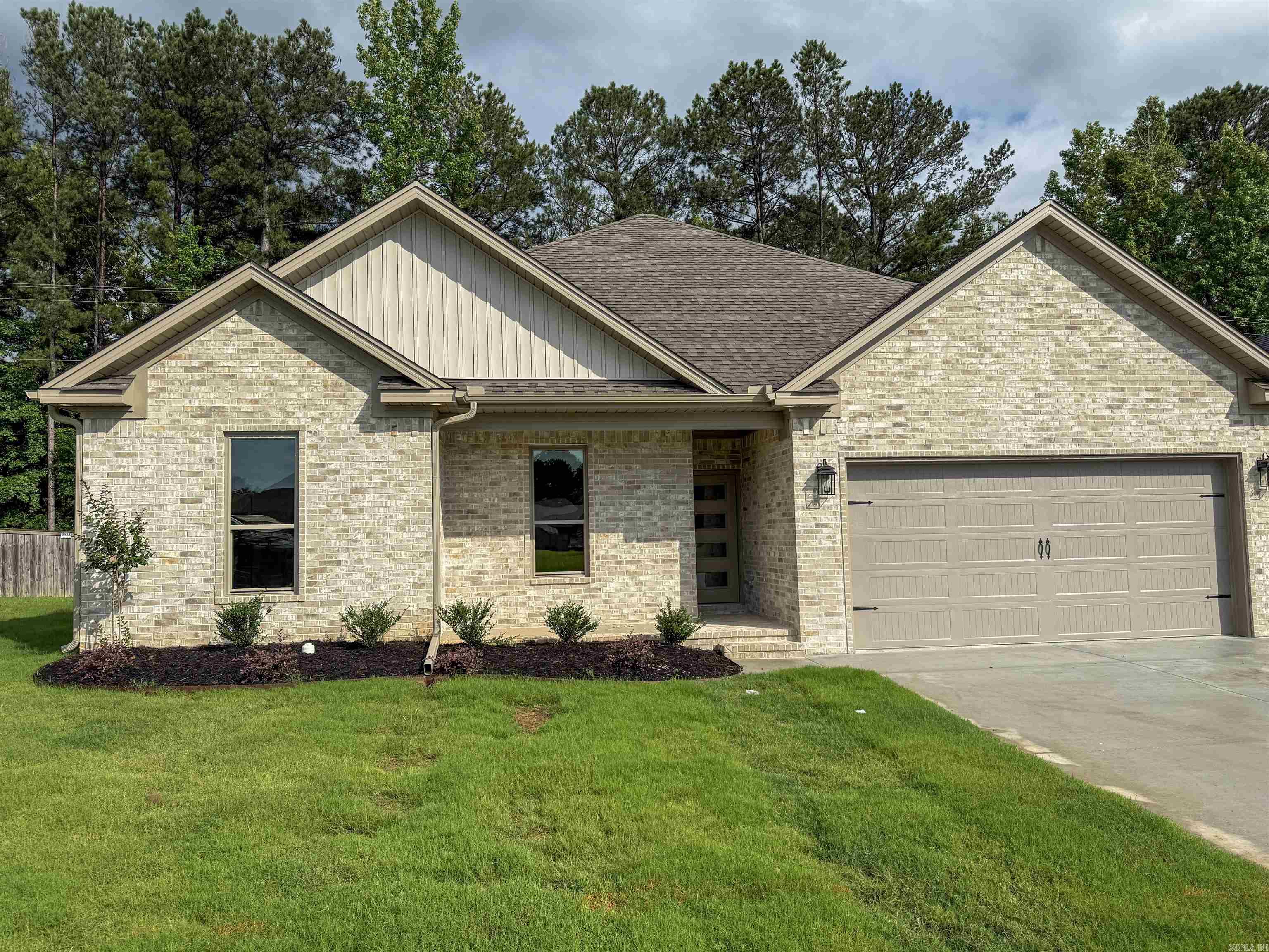 This stunning new construction in Foxwood Gardens sits on a quiet cul-de-sac and offers 3 bedrooms, 2.5 bathrooms, a bonus room, and 2,140 sq ft of beautifully finished living space. The open-concept layout features a spacious living area with a sleek LED fireplace framed by a shiplap chase. The kitchen boasts quartz countertops, a large island with seating, stainless steel appliances, and a subway tile backsplash. The primary suite is conveniently located on the main floor and includes a tray ceiling, walk-in closet, and a spa-like bath with dual vanity and a walk-in tiled shower. Upstairs, a versatile bonus room offers space for work, play, or relaxation. Two additional bedrooms share a stylish full bath. Luxury vinyl plank flooring, stair lights, recessed lighting, and modern finishes add warmth and style throughout. The laundry room includes built-in floating shelves for extra storage. Enjoy outdoor living on the covered porch with a patio deck and the convenience of a 2-car garage. Call or text today to coordinate your personal tour!