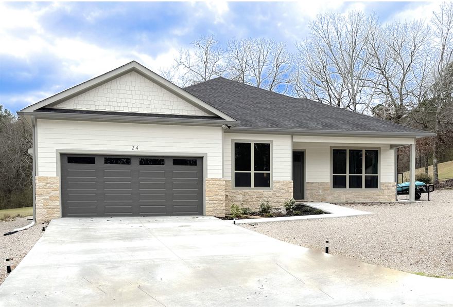 Escape to your own private oasis on the Coronado Golf Course in Hot Springs Village! This stunning better than new-construction home delivers luxury, tranquility, and an unbeatable lifestyle.  The open-concept design features soaring ceilings and seamless flow from a spacious living area with tasteful built-ins to a gourmet kitchen centered around a massive waterfall quartz island—perfect for entertaining and everyday living. Floor-to-ceiling windows bathe the home in natural light while framing breathtaking panoramic views of the #12 fairway's park-like grounds.  The primary suite is a true retreat, boasting a spa-like bathroom with dual vanities and an oversized walk-in shower. Step out to the enormous covered back patio to soak in the serene, manicured landscape right from your doorstep.  Highly energy-efficient and low-maintenance throughout, this home lets you enjoy the good life with easy access to the Coronado Fitness Center, tennis and pickleball courts, and the scenic 18-hole executive golf course.  You're not just buying a home—you're investing in an exceptional lifestyle.