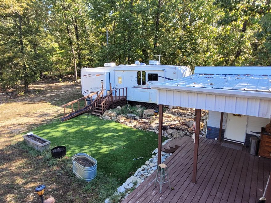 Escape to your own private slice of paradise! The property is located in Fulton County, Arkansas near Mountain Home. This secluded lot is the ultimate ready-to-go retreat for Norfork Lake living and glamping, featuring two campers already set up for immediate enjoyment. Enjoy stunning, multi-level views of the lake from the expansive large deck and the added second-level deck, perfect for entertaining or quiet mornings. The property comes fully equipped with a well, septic, and electricity, plus a dedicated shop building with electricity—an ideal space to store your boat, kayaks, and other water toys. Surrounded by private woods and easily accessible via gravel county road frontage, you're just three miles from a boat launch for quick access to the water. This is a fantastic, turnkey spot for a family weekend getaway or a full vacation spot.