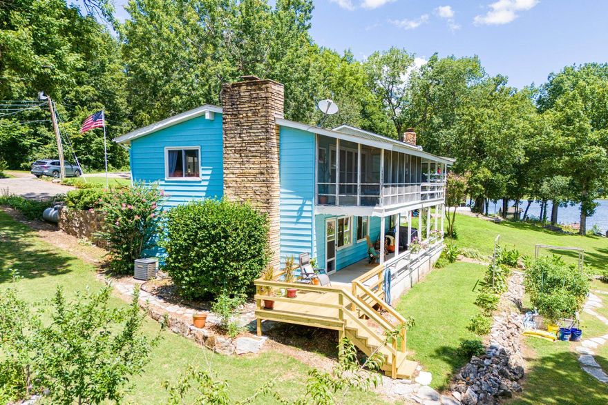 Dream setting, Beautiful LAKE HOME on Lake Cherokee! Natural light and expansive lake views will provide viewing pleasure all year long whether from the large picture windows or from the large screened in back porch. The landscaped lawn gently slopes toward the 37 acre no wake Lake reaching a private dock where you can fish, swim, float, or simply relax on your own lake front property.  The home is roomy both inside and out with plenty of room to roam and spread out.  The two bedrooms are large, with large closets. Two separate living areas provide opportunity for extra sleeping arrangements, possibly even an extra bedroom. One bathroom has a walk in shower and the other has a brand new shower/tub combo. There is a separate, quiet office/craft room with a fabulous lake view and separate entrance. The huge laundry/utility room is very well appointed with extra workspace and loads of storage space. This lovely lake home is move in ready.  This is not one that you will have to work on to enjoy.  Lake Life is rewarding. Come see how it feels!