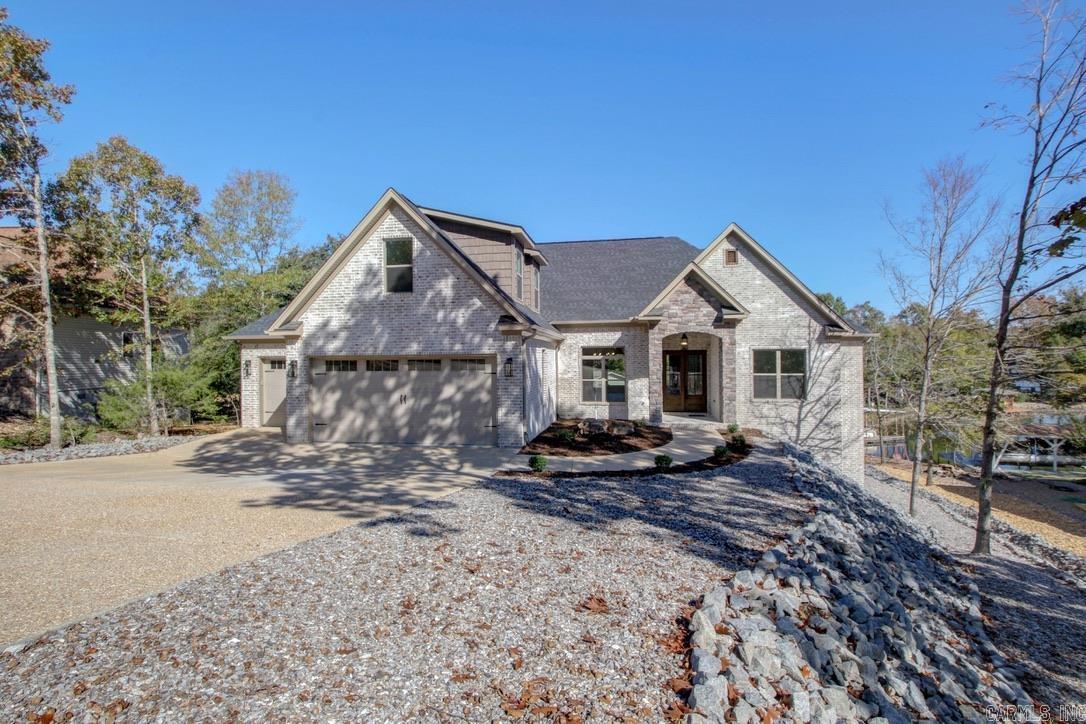 This NEW CONSTRUCTION 3 bedroom, 3.5 bath offers luxurious finishings with exceptional lake views. The attractive all brick exterior is complemented with stone accents and an outdoor fireplace. The interior features a coffered ceiling in the great room, a genuine marble backsplash, a dedicated office, and a completely finished bonus room that could easily be a 4th bedroom. A nice sized storage/workshop area is located at the rear of the home under the patio. This home was built by McMillan Homes and comes with a 1 year builders warranty. If waking up to the beauty of Lake Balboa and relaxing in the comfort of a gated community is what you're looking for, then call today to schedule a showing. Located inside Hot Springs Village.