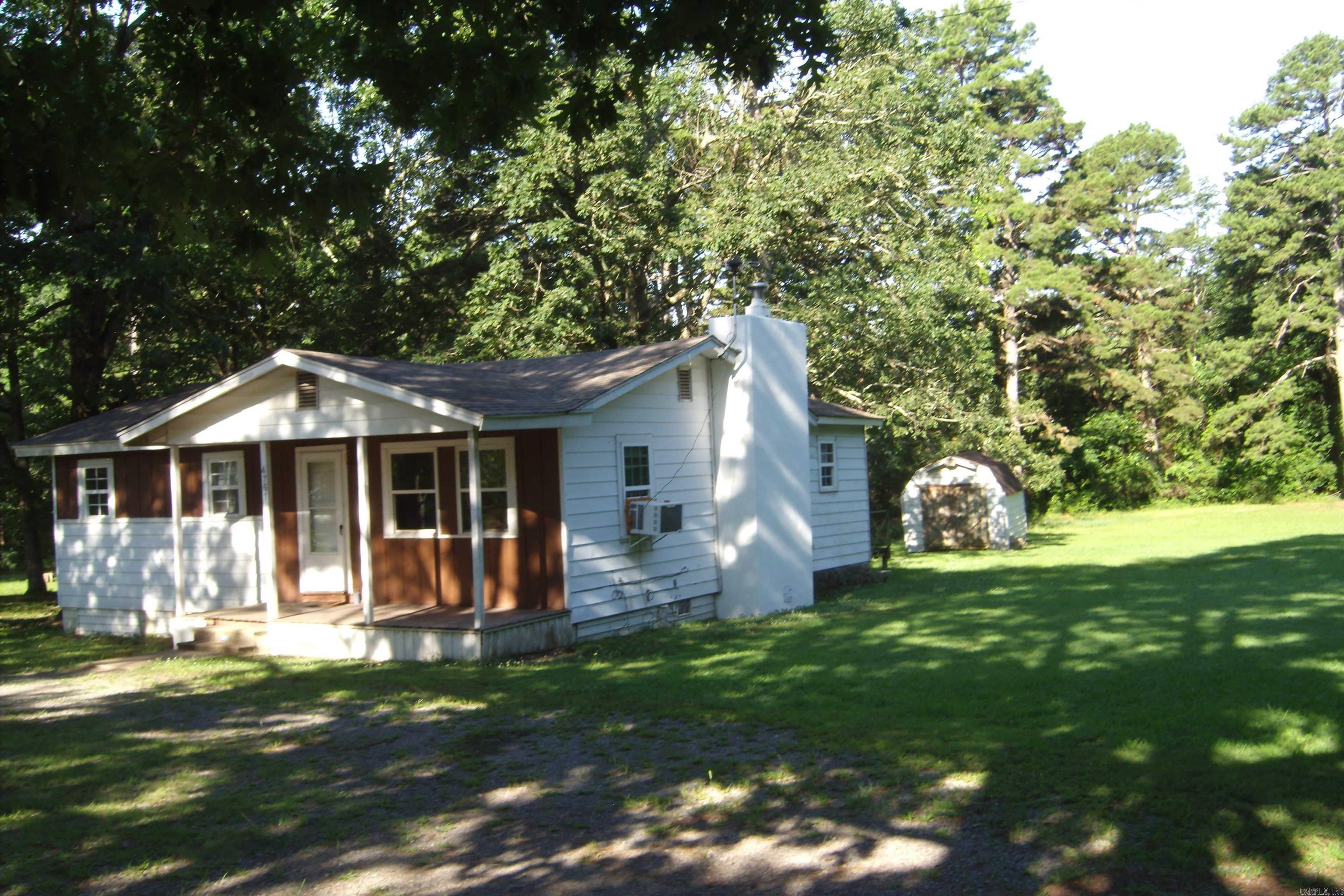 Great starter home, hard wood & vinyl floors, 3 bed rooms 1 bathlarge utility room, living room, kitchen has almost new refrigerator, freestanding electric cook stove, insulated windows, new roof in 2024, fire place. nice storage building, garden spot, fruit trees, plenty shade trees.