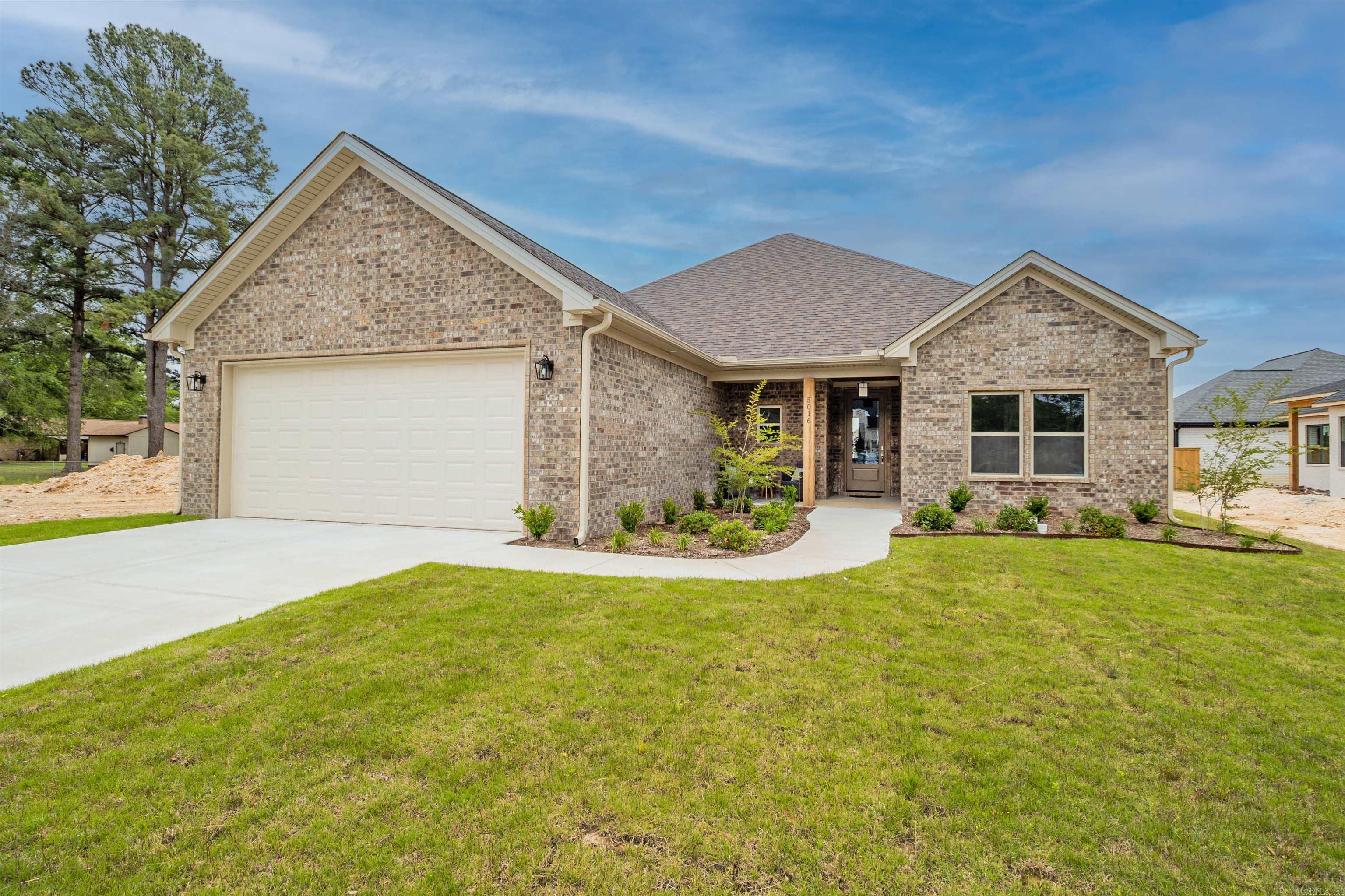 This stunning new construction brick home, is located in the new Benton subdivision, Spencer's Crossing. This home has lots of extras, that make it stand out. We start with a split floor plan, that offer's a spacious living, kitchen and dining area. The open concept is heightened with beautiful Vaulted ceilings with a gorgeous stained beam that really stands out. They say the kitchen is the heart of the house, and in this house you will fall in love with the kitchen, with quartz kitchen cabinets, freestanding gas stove, large bar area, nice walk in pantry, and yes the refrigerator is included. Perfect living area to sit in front of the gas fireplace while hanging out with family or entertaining friends. Want to enjoy the beautiful weather, just step out onto the large covered patio to have a peaceful outdoor retreat. A very spacious master bedroom with luxury bathroom. 2 nice size bedrooms and bathroom. Gas HVAC, insulated garage walls and ceilings with floored attic, 21 X 20 decking over garage, Gas Tankless Hot water tank, are just a few of the special extra's. Back yard will be fully fenced. Schedule soon.