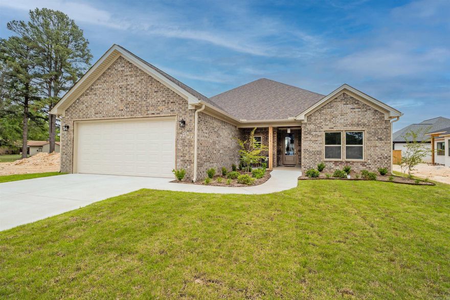 This stunning new construction brick home, is located in the new Benton subdivision, Spencer's Crossing.  This home has lots of extras, that make it stand out. We start with a split floor plan, that offer's a spacious  living, kitchen and dining area.  The open concept is heightened with beautiful Vaulted ceilings with a gorgeous stained beam that really stands out.  They say the kitchen is the heart of the house, and in this house you will fall in love with the kitchen, with quartz kitchen cabinets, freestanding gas stove, large bar area, nice walk in pantry, and yes the refrigerator is included. Perfect living area to sit in front of the gas fireplace while hanging out with family or entertaining friends.  Want to enjoy the beautiful weather, just step out onto the large covered patio to have a peaceful outdoor retreat. A very spacious master bedroom with luxury bathroom. 2 nice size bedrooms and bathroom. Gas HVAC, insulated garage walls and ceilings with floored attic, 21 X 20 decking over garage, Gas Tankless Hot water tank, are just a few of the special extra's. Back yard will be fully fenced. Schedule soon.