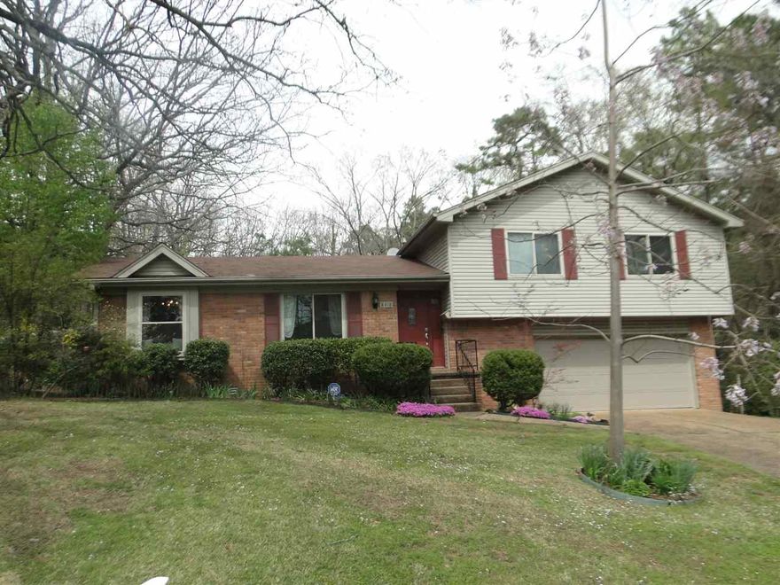 Inviting Leawood home with updated kitchen is open to den with gas log fireplace. The kitchen has a large breakfast bar that seats up to four, nice white cabinetry, electric range and dishwasher. Kitchen and den have beautiful hardwood flooring and carpet in the living room, dining room and bedrooms. Huge private backyard with patio, deck, extra landscaping and outside storage. Large 2 car garage and laundry.