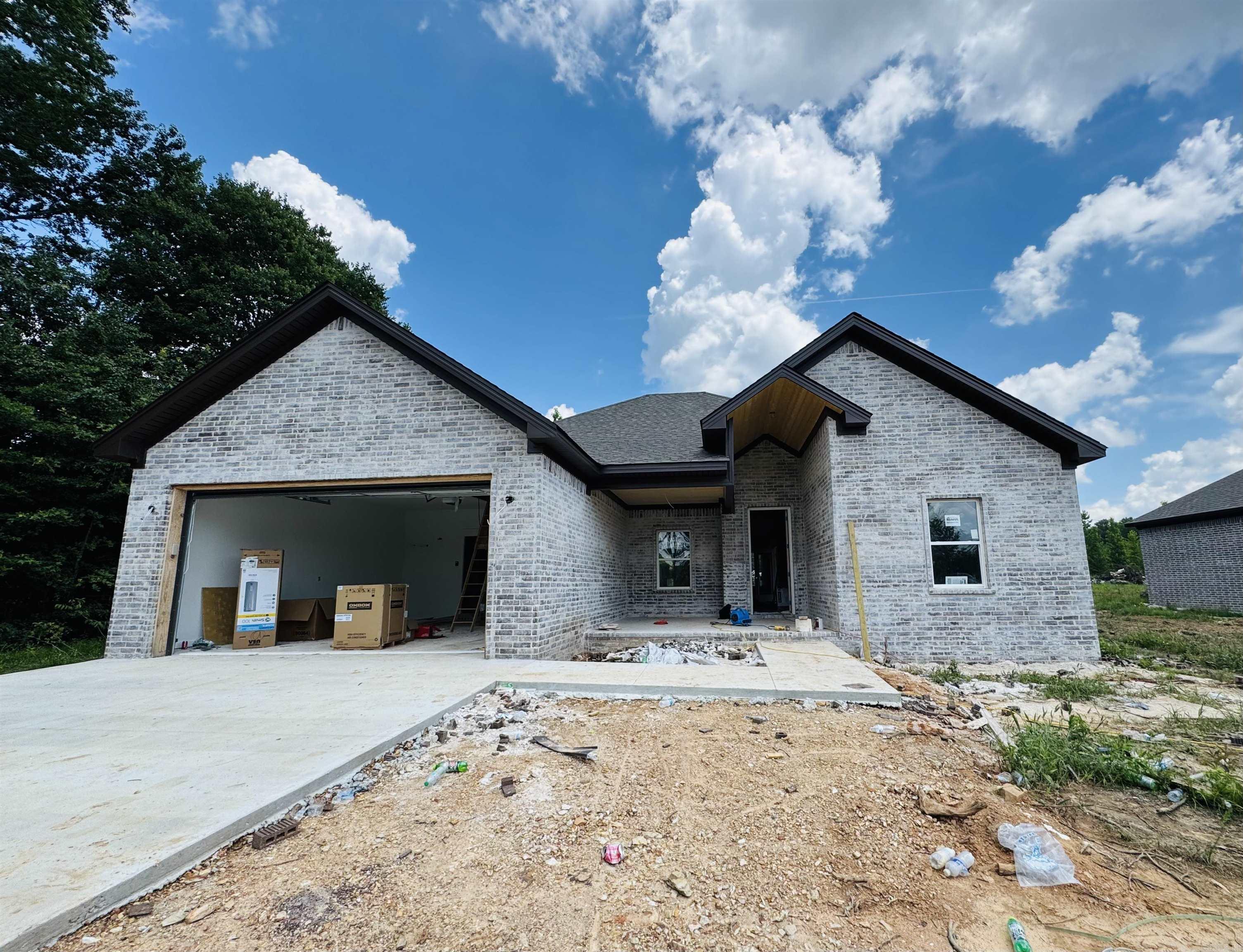 This brand-new all-brick home combines quality craftsmanship with timeless comfort. Featuring 3 bedrooms, 2 bathrooms, and 1,800 square feet of open living space, it sits on nearly an acre of landāoffering both privacy and room to grow. The open floor plan flows beautifully, and the wood-burning fireplace brings warmth and charm to the heart of the home. Outside, a spacious sitting porch invites you to slow down and enjoy the peaceful surroundings. If you're looking for a move-in-ready home with space, character, and classic style, this one has it all.