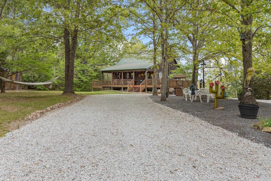 If you’ve been dreaming of a peaceful retreat with unforgettable views, this 3-bedroom, 2-bath log cabin on over seven park-like acres delivers. A full four-sided wraparound porch offers stunning views of the Tyler Bend area of the Buffalo National River. Located just five minutes from Gilbert and Grinder’s Ferry access and moments from Tyler Bend, you’ll enjoy easy access to some of the river’s most loved destinations. You’re also just minutes from local favorites—Ferguson’s Country Store and Coursey’s Smoked Meats. An additional homesite at the front of the property already has utilities in place—perfect for a guest house or income-producing rental. The lower level features a bedroom/family room combo with its own kitchen and private outdoor access, ideal for guests or multi-generational living. Extras include an RV hookup, two-car carport, outbuilding, and shed. Whether you're looking for a full-time home, weekend getaway, or investment, this one checks all the boxes.