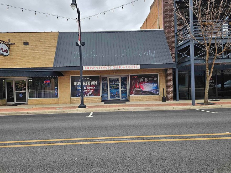 Located in Paragould's Downtown Historic District on the South end.  This property has many uses. It has a full kitchen with grease trap/venation, grill, refrigerator, shelves for storage, lower cabinet below bar, two half baths, storage rooms in the back, front window display, nice front and back door entrance. Updated improvements are: tankless water heater in 2025, roof and new wiring to the roof's central units in 2024/25, completely remolded backside of building in 2025. There is parking both in front and behind the store. Only the real estate is being sold. Not the business. See Agents Remarks