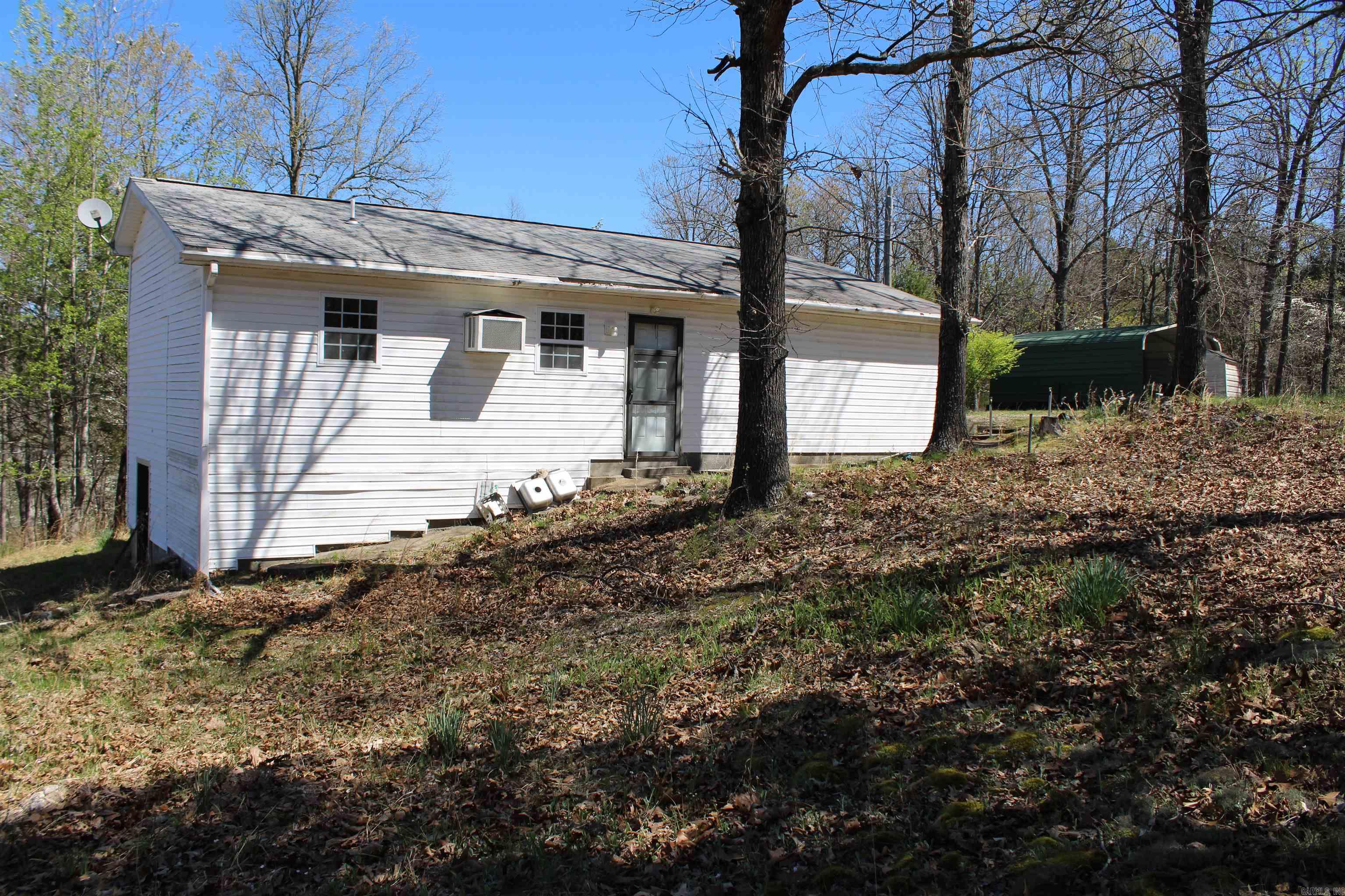 MINUTES FROM LAKE NORFORK ACCESS! This amazing property is sitting at the end of a dead-end road and touches the government strip! Located minutes from town and unrestricted! You will love all of the beautiful fruit trees and gorgeous dog wood trees. Featuring two bedrooms, two full baths, sunroom, 8x8 green house, and a detached carport. Large Walk-in cinderblock crawl space with Water heater and well pressure tank, plus extra storage space. Home is waiting for you to come show it some love and bring it back to life! Property is sold as is.